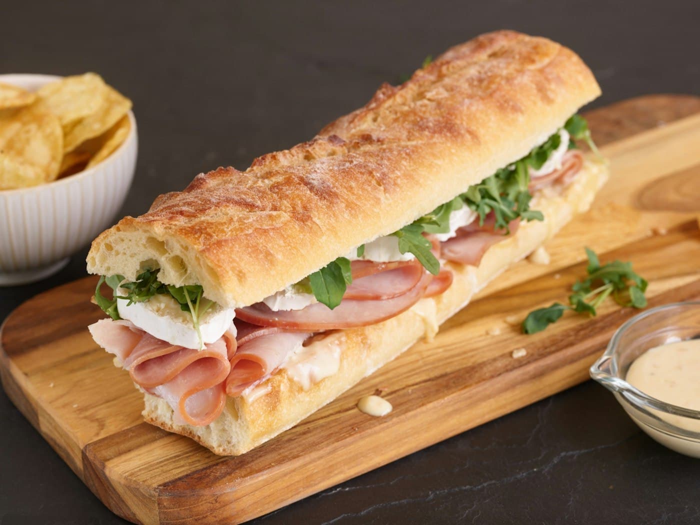 Fresh panino sandwich on a wooden board